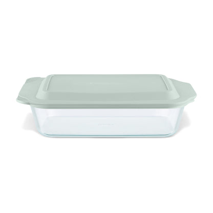 Glass baking dish with a green lid on a white background