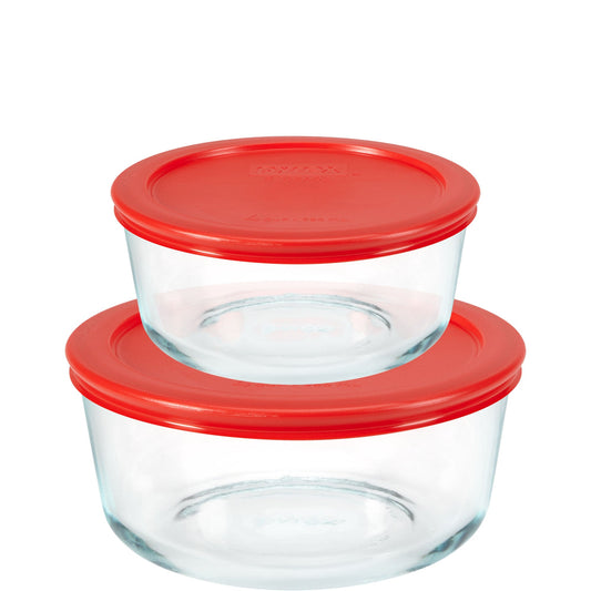 Two glass food storage containers with red lids on a white background