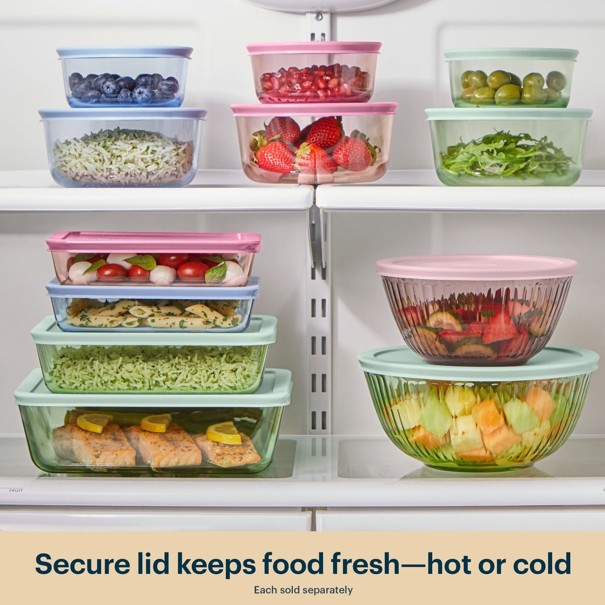 Glass food storage containers with colorful lids neatly organized in a refrigerator.
